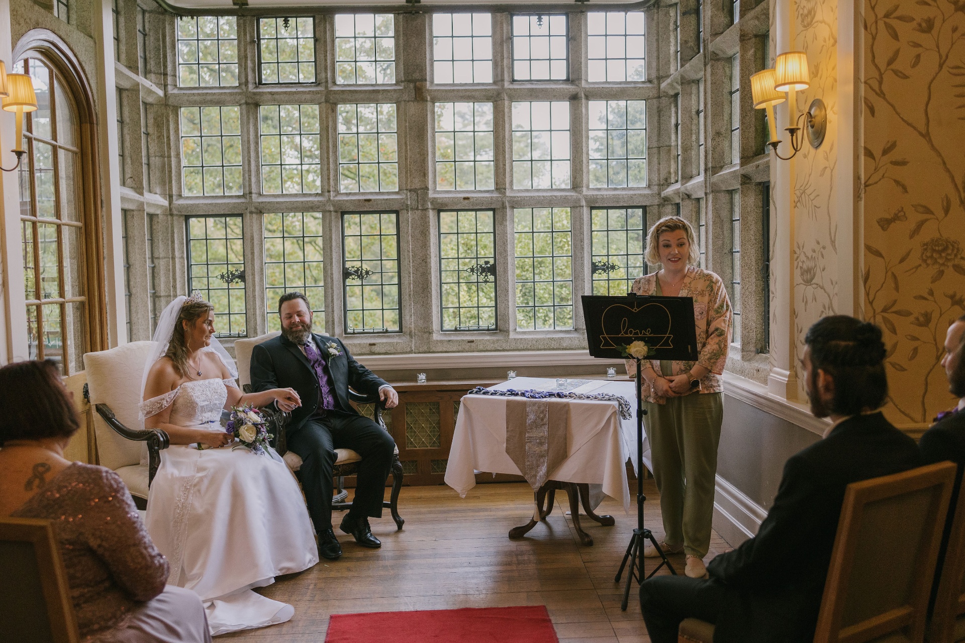 Áine creating a personal ceremony in a manor drawing room